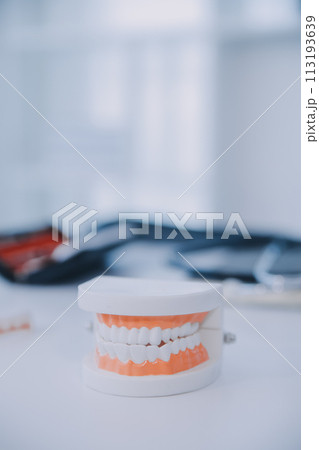 Denture and dental tools,dental mirror on white background Denture and dental tools,dental mirror on white background 113193639