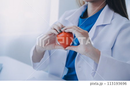 Doctor explaining heart to elderly patient. Doctor explaining the heart model. Doctors pen point to a model of the heart Doctor explaining heart to elderly patient. Doctor explaining the heart model. Doctors pen point to a model of the heart 113193696