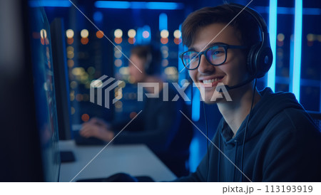 Man Wearing Headphones Working on Computer Man Wearing Headphones Working on Computer 113193919