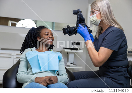 Dentist making photo of patient mouth after oral care Dentist making photo of patient mouth after oral care 113194059