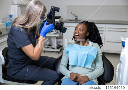 Dentist making teeth photo after oral treatment in clinic Dentist making teeth photo after oral treatment in clinic 113194060