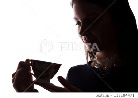 Silhouette of a young woman with a cup Silhouette of a young woman with a cup 113194471