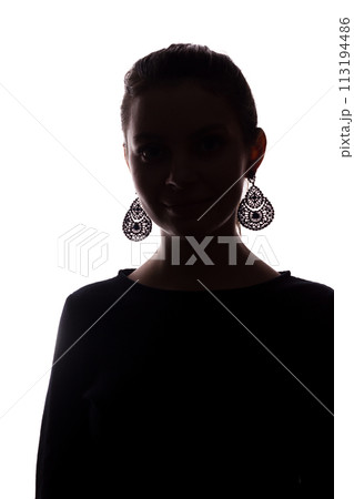 Young girl with earrings looks straight ahead, portrait isolate silhouette Young girl with earrings looks straight ahead, portrait isolate silhouette 113194486