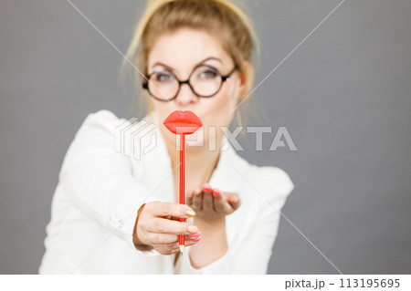 Happy elegant woman holding carnival accessoies on stick 113195695