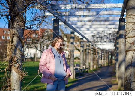 Winter Fun in Bitigheim-Bissingen: Beautiful Girl in Pink Jacket Amidst Half-Timbered Charm. a lovely girl in a pink winter jacket standing in the archway of the historic town of Bitigheim-Bissingen Winter Fun in Bitigheim-Bissingen: Beautiful Girl in Pink Jacket Amidst Half-Timbered Charm. a lovely girl in a pink winter jacket standing in the archway of the historic town of Bitigheim-Bissingen 113197848