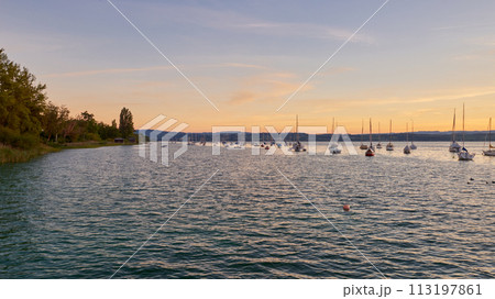 Bodensee Lake Sunset Panorama. Evening Sunlight Over Tranquil Waters. Sunset Vista at Lake Bodensee in Germany. Bodensee Lake Sunset Panorama. Evening Sunlight Over Tranquil Waters. Sunset Vista at Lake Bodensee in Germany. 113197861