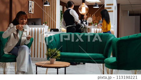 Employee giving room access card and passport to client after doing check in process, asian woman arriving at hotel and registering. Tourist receiving key and id documents at reception. 113198221