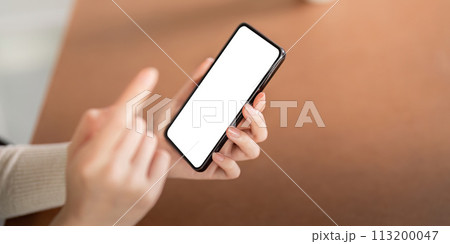 Mockup of a woman holding and using mobile phone with blank screen while laying down on the floor with feel relax 113200047