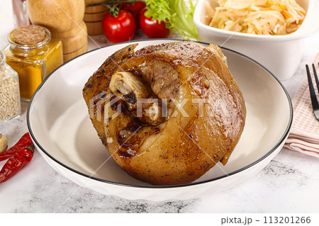 Baked pork knee with spices 113201266