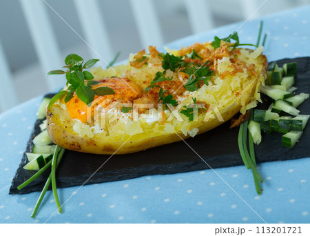 Baked potato with herbs, egg and cucumbers Baked potato with herbs, egg and cucumbers 113201721