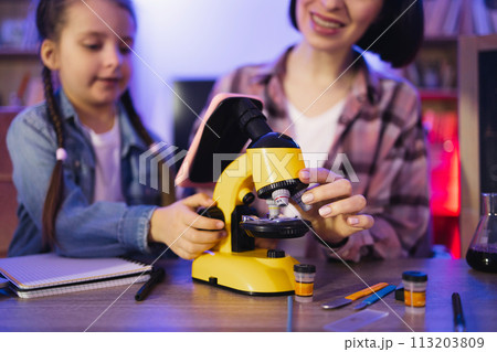 Concept of parenthood and teaching, leisure time in evening at home. Concept of parenthood and teaching, leisure time in evening at home. 113203809