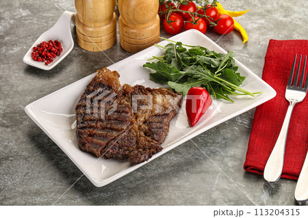 Grilled chuck roll steak with arugula Grilled chuck roll steak with arugula 113204315