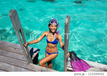 Travel Vacation Snorkeling. Snorkel swim woman in tropical coral reef resort. This image is completely unretouched and unedited and model is with no makeup. Authentic real people. Original Raw Image Travel Vacation Snorkeling. Snorkel swim woman in tropical coral reef resort. This image is completely unretouched and unedited and model is with no makeup. Authentic real people. Original Raw Image 113204432