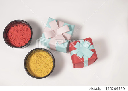 Colorful Holi powder with gift box on white background for Indian Holi festival celebration. Top view Colorful Holi powder with gift box on white background for Indian Holi festival celebration. Top view 113206520