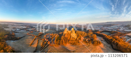 Trosky medieval castle ruins at cold morning sunrise time. Bohemian Paradise, Czech: Cesky raj, Czechia. Aerial view from above. 113206571