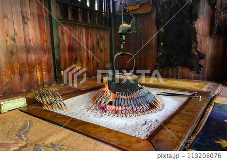 Grilled Char (Iwana) cooking on a traditional Japanese fireplace Grilled Char (Iwana) cooking on a traditional Japanese fireplace 113208076