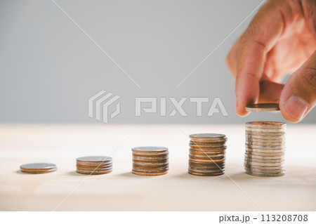 Graph featuring an ascending arrow symbolizes the surging real estate market. Alongside, house model stack of coins symbolize inflation, economic growth, insurance service expenses. Value is on rise. 113208708