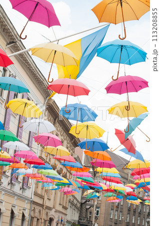 Many colorful umbrellas on the open sky Many colorful umbrellas on the open sky 113208855