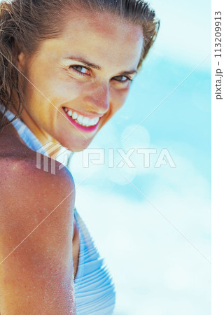 smiling young woman on beach 113209913
