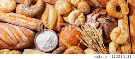 Fresh baked bread, flour and wheat ears, top view 113210131