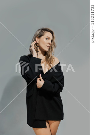 Beautiful woman with a long hair in a black jacket Beautiful woman with a long hair in a black jacket 113211733