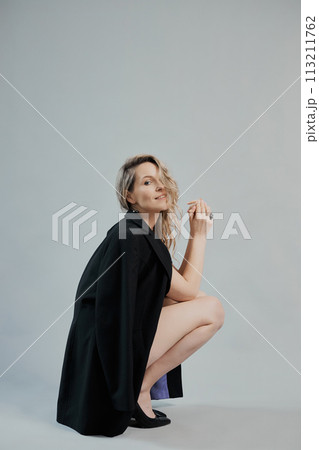 Beautiful woman with a long hair in a black jacket Beautiful woman with a long hair in a black jacket 113211762