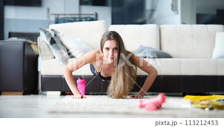 Confident Girl achieves goals by training at home. Confident Girl achieves goals by training at home. 113212453
