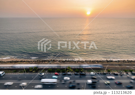 Road and railway track along coast at sunset in Colombo. 113213620