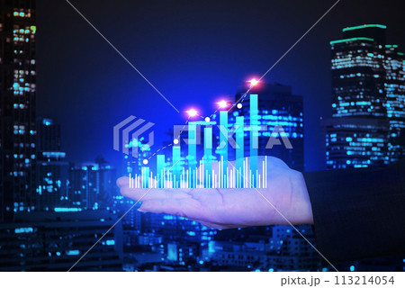 Chart business show up trend data on businessman 's hand with blur background night city , business finance concept. 113214054