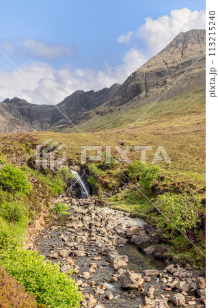 Fairy Pools on Skye, a stream meanders through stones under Cuillin mountain shadows Fairy Pools on Skye, a stream meanders through stones under Cuillin mountain shadows 113215240