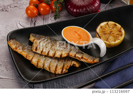 Grilled seabass fillet with lemon Grilled seabass fillet with lemon 113216097