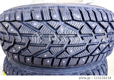 Winter vehicle tires stacked up for sale in the store Winter vehicle tires stacked up for sale in the store 113216218