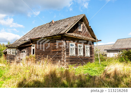 Old abandoned rural wooden house in russian village in summer sunny day Old abandoned rural wooden house in russian village in summer sunny day 113216268