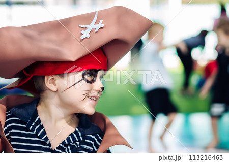 Boy Cat Pirate costume. Halloween party in kindergarten. Aqua makeup painted kids face. Bright festive Boy Cat Pirate costume. Halloween party in kindergarten. Aqua makeup painted kids face. Bright festive 113216463