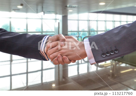 Business handshake for a closing deal Business handshake for a closing deal 113217760