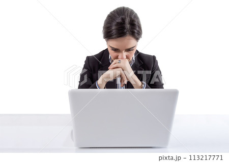 Stressed and tired business woman with a laptop Stressed and tired business woman with a laptop 113217771