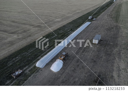 Silo bag work in pampas countryside, grain storage in La Pampa, Argentina 113218233