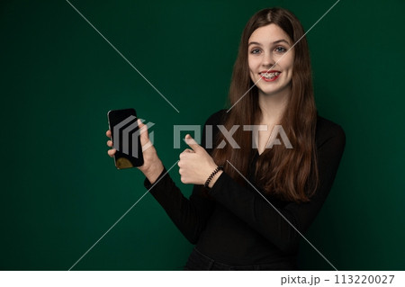 Woman Holding Cell Phone and Giving Thumbs Up 113220027