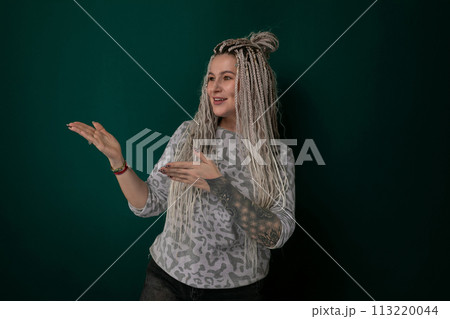 Woman With Long Blonde Hair in Front of Green Wall Woman With Long Blonde Hair in Front of Green Wall 113220044