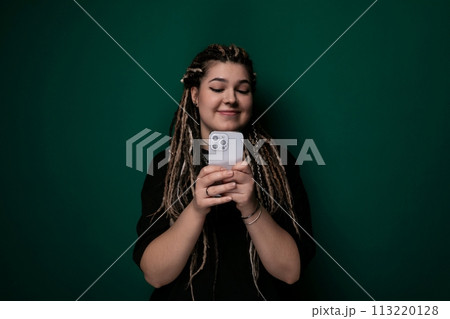 Woman With Dreadlocks Holding Cell Phone Woman With Dreadlocks Holding Cell Phone 113220128