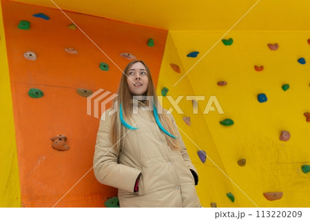 Woman Standing in Front of Climbing Wall Woman Standing in Front of Climbing Wall 113220209