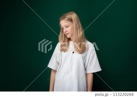 Woman Standing in Front of Green Wall 113220268