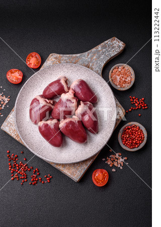 Raw turkey or chicken hearts with salt and spices Raw turkey or chicken hearts with salt and spices 113222442
