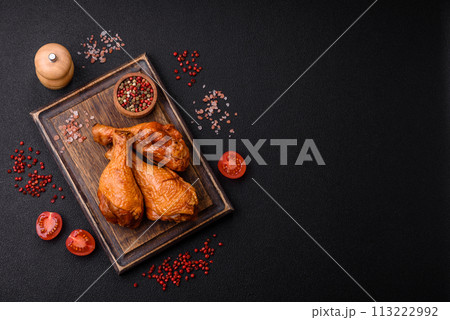 Delicious chicken legs baked on the grill with salt, spices and herbs 113222992