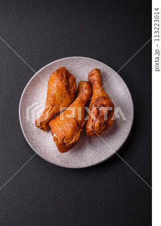 Delicious chicken legs baked on the grill with salt, spices and herbs 113223014