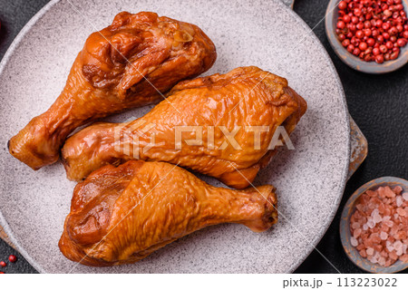 Delicious chicken legs baked on the grill with salt, spices and herbs Delicious chicken legs baked on the grill with salt, spices and herbs 113223022