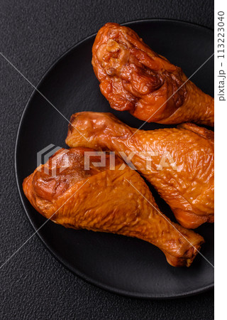 Delicious chicken legs baked on the grill with salt, spices and herbs Delicious chicken legs baked on the grill with salt, spices and herbs 113223040