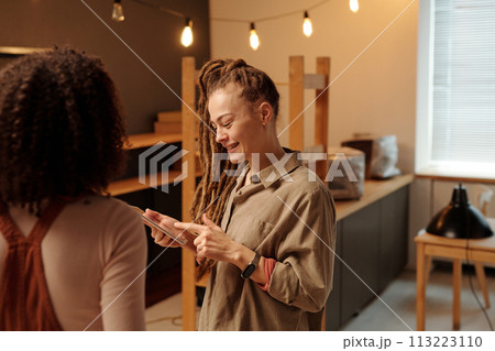 Entrepreneur pointing at tablet screen 113223110