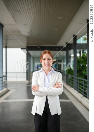Portrait of happy Asian Businesswomen looking at the left with the aisle background. 113223914