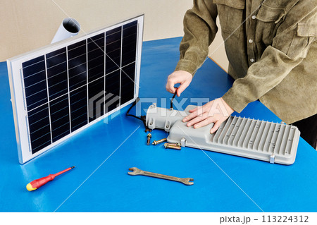 Fully autonomous, stand alone solar powered light, installation on mounting bracket before fixing to pole or wall. Fully autonomous, stand alone solar powered light, installation on mounting bracket before fixing to pole or wall. 113224312